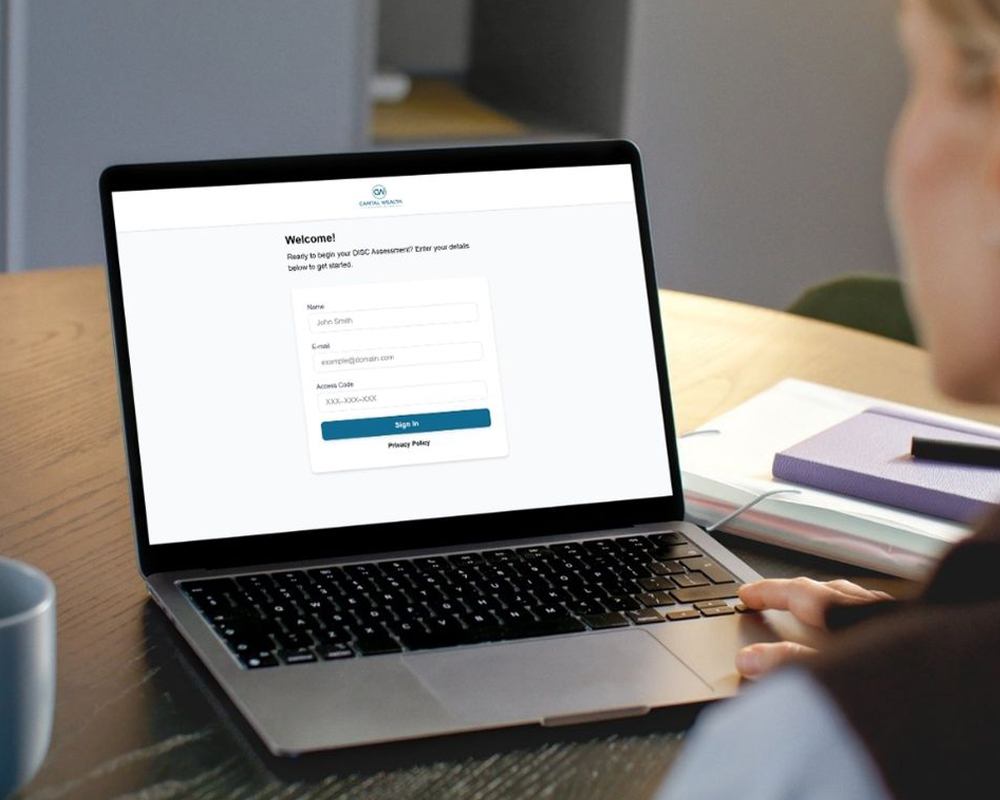 Laptop displaying a white-labeled DISC assessment login screen customized with an organization’s branding.